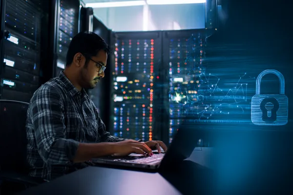 A woman smiling while playing online games on her laptop, surrounded by neon casino elements, showcasing CHAMBAWINPH’s diverse game collection.
